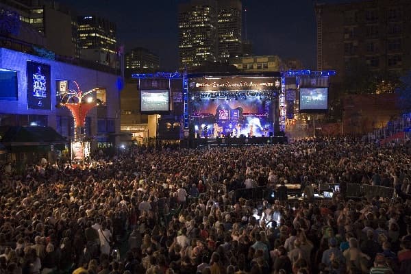 Massive crowd at an outdoor stage at the Montréal International Jazz Festival in the Quartier des Spectacles