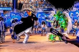 Performers in elaborate blue and green Amazonian costumes at the Parintins Folklore Festival Bumbódromo