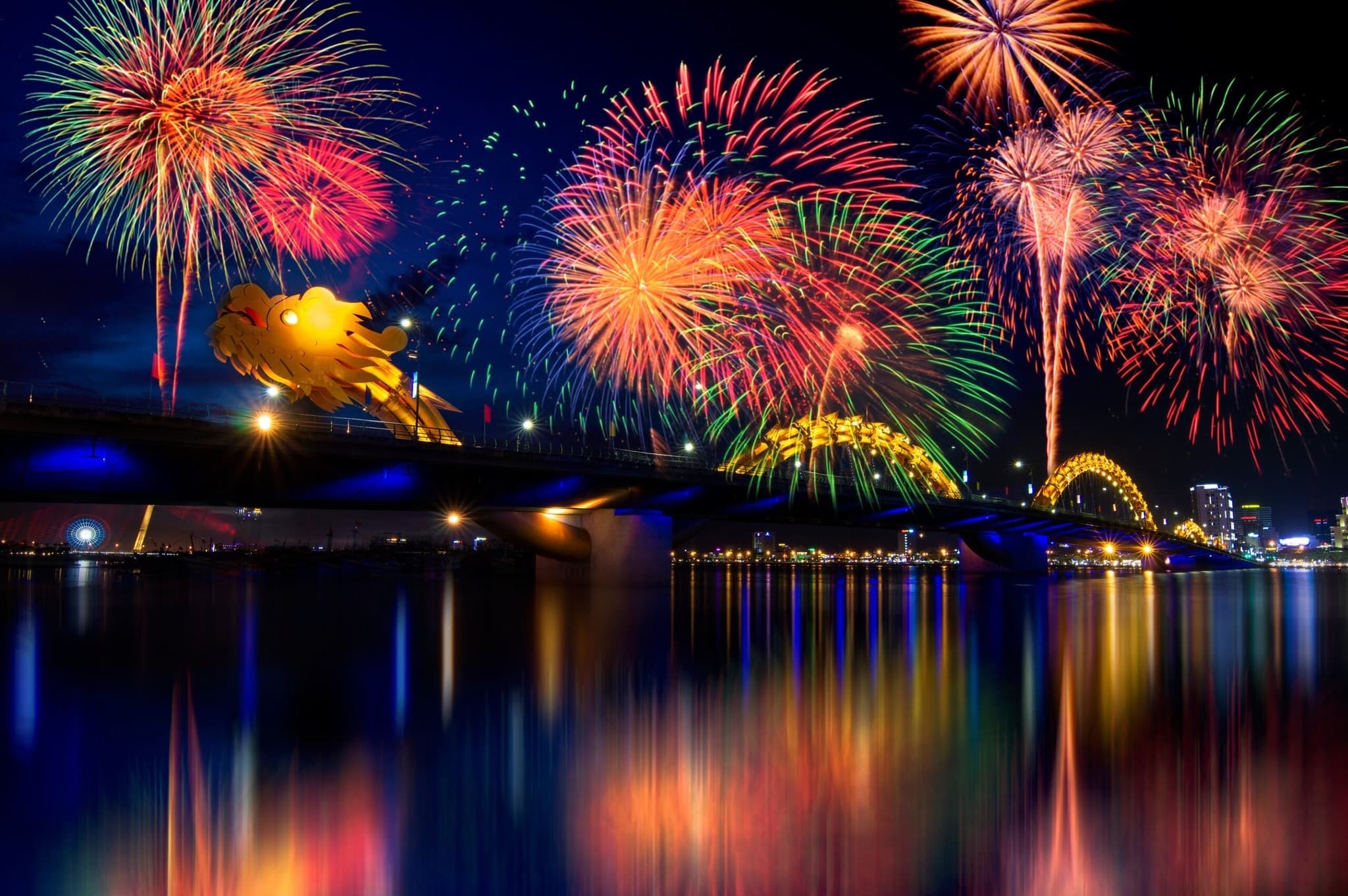 Multi-country fireworks display over the Han River with Da Nang's Dragon Bridge illuminated