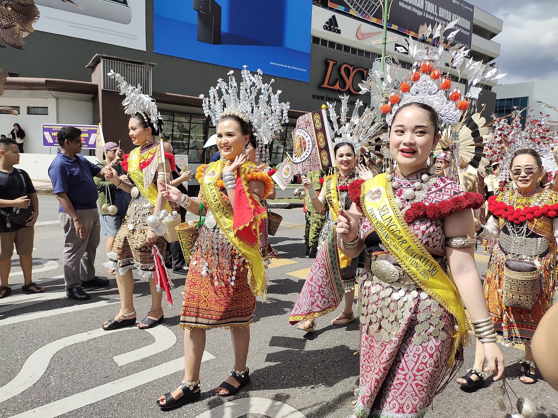 Dancers in elaborate beaded headdresses and traditional dress at the Gawai Dayak harvest festival parade in Sarawak, Malaysian Borneo