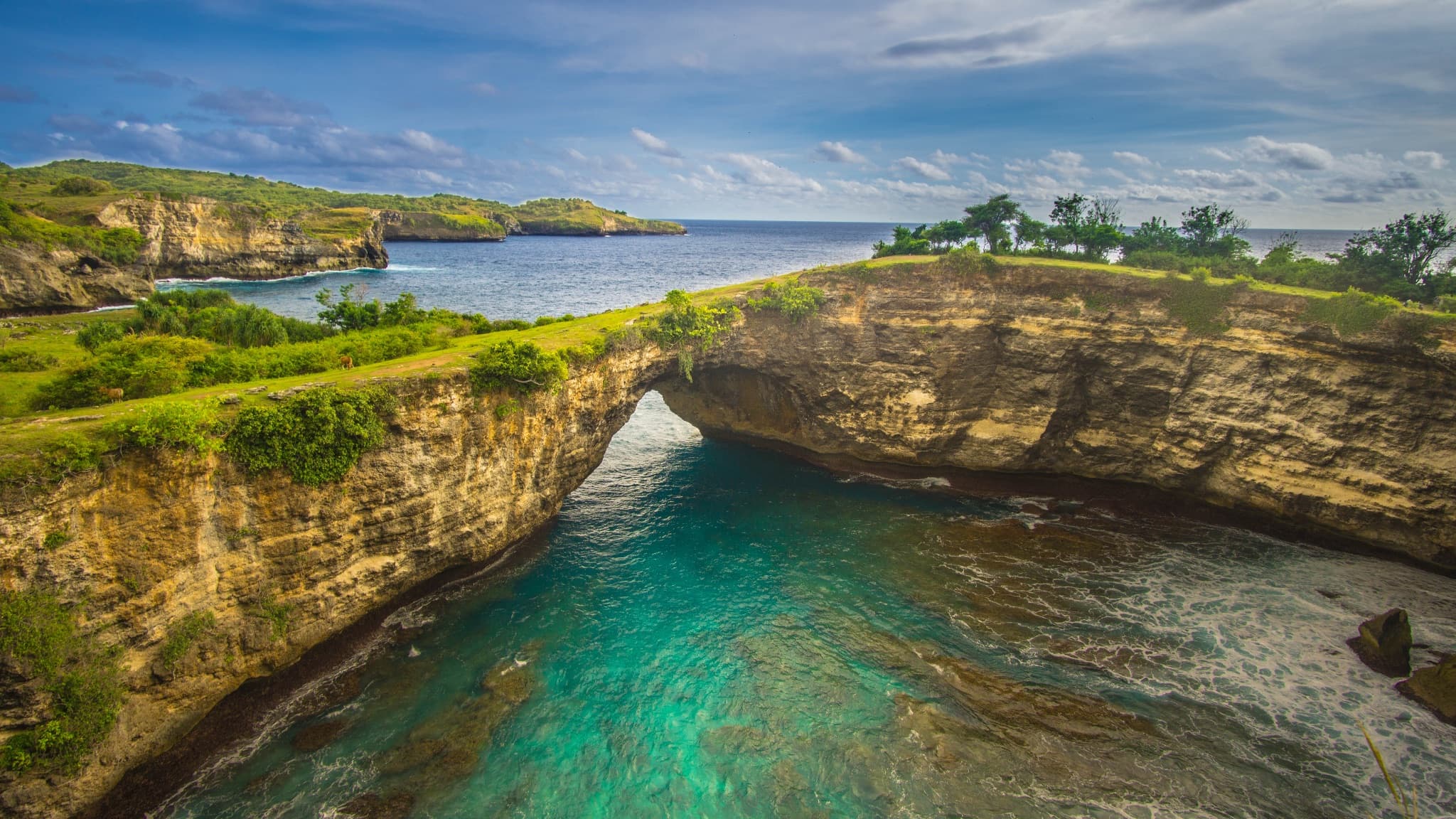 Broken Beach natural limestone arch at Nusa Penida, Bali, with turquoise water below