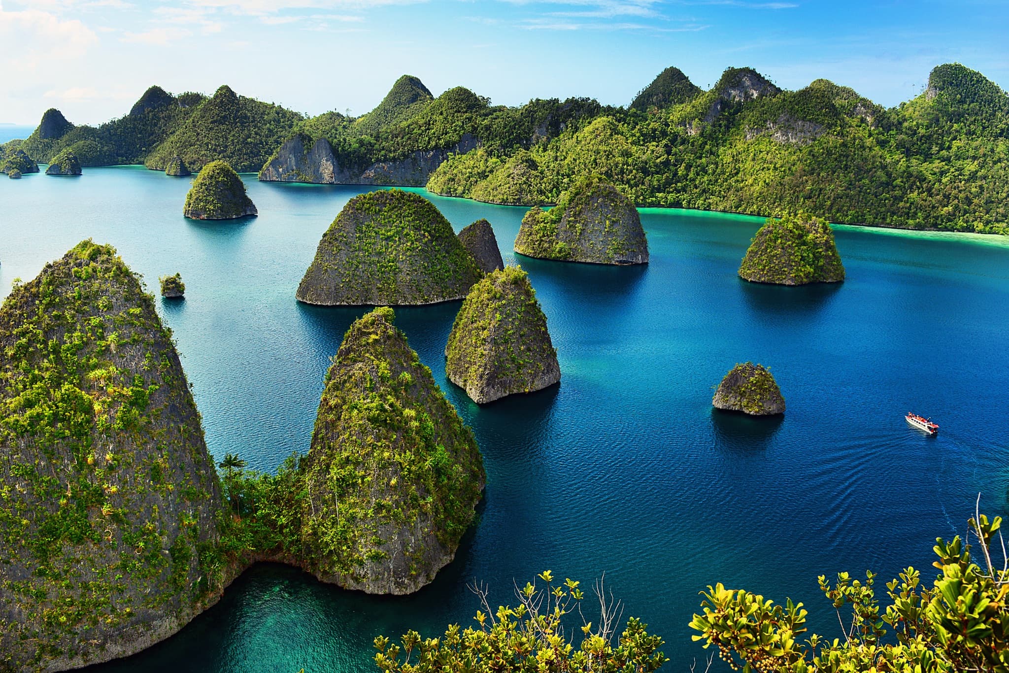 Aerial view of karst limestone islets and turquoise water in Raja Ampat, West Papua