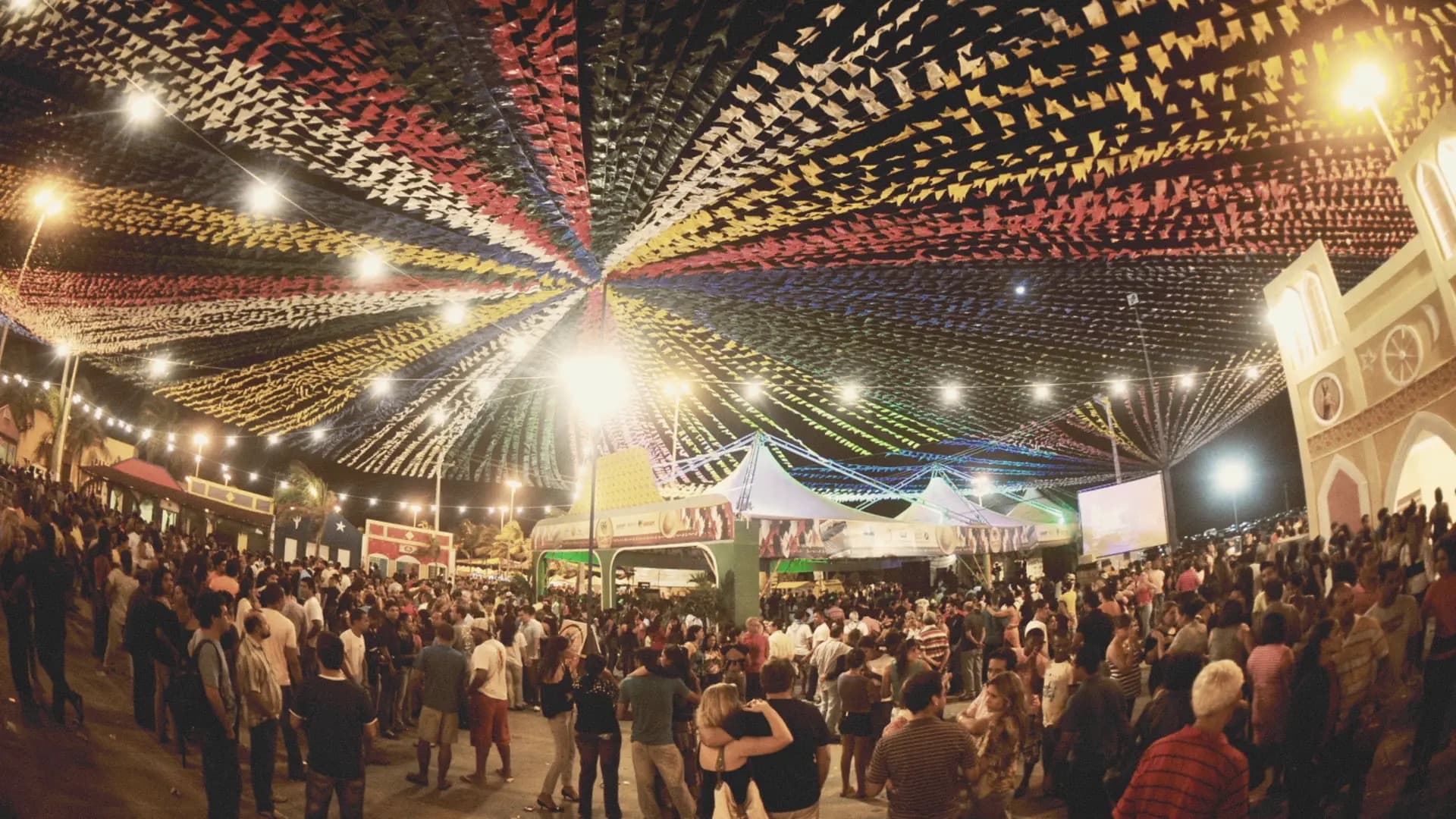 Colorful overhead streamers and crowds at the Festa de Santo António street celebrations in Lisbon