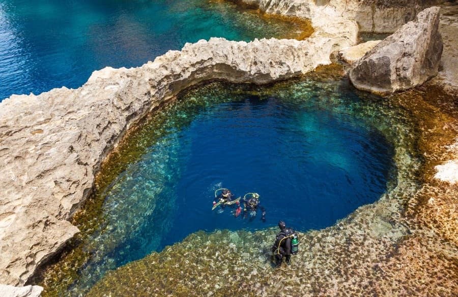 Snorkeller floating over the impossibly clear water of Silfra Fissure between two tectonic plates in Iceland